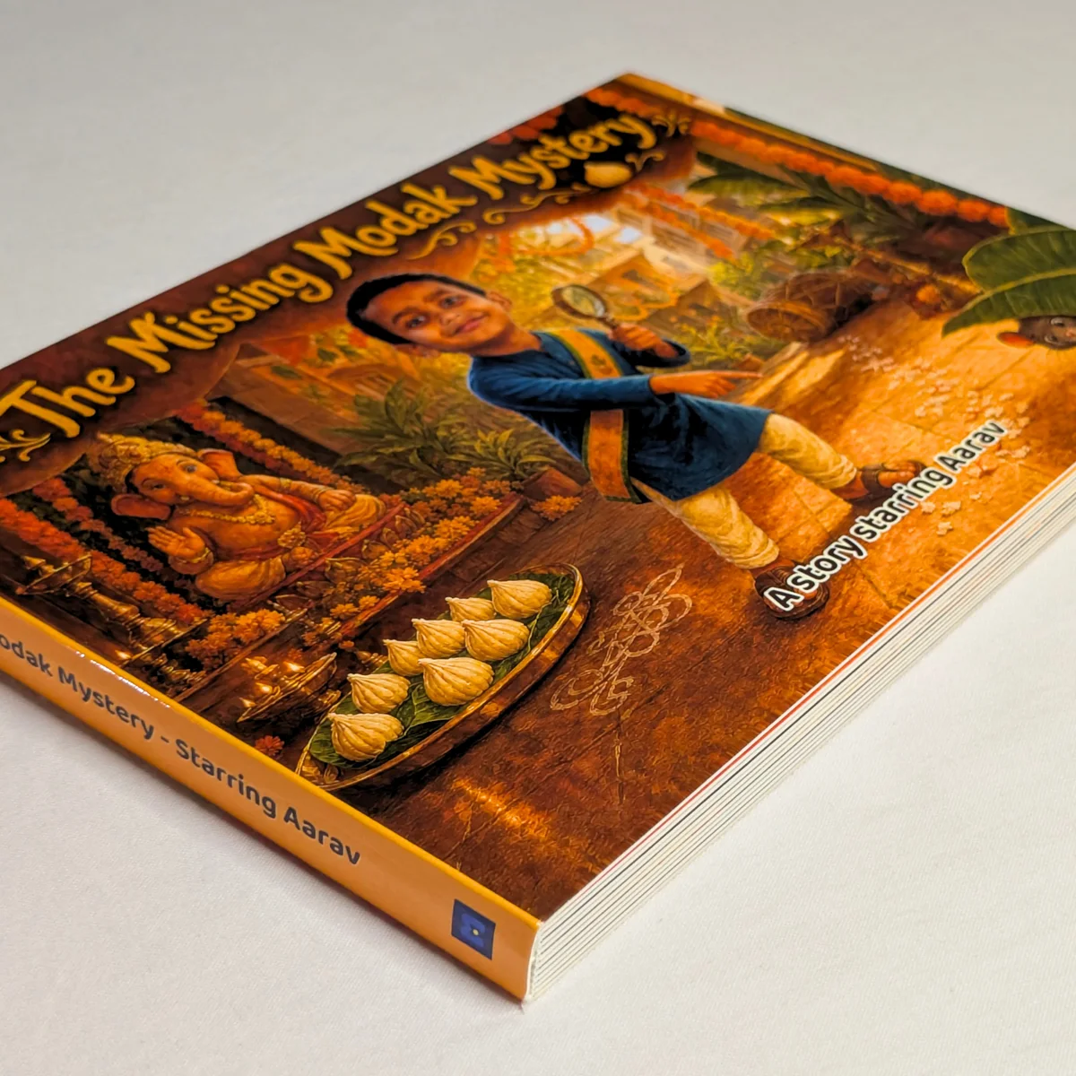 Aarav's personalized Missing Modak Mystery hardcover showing its premium binding