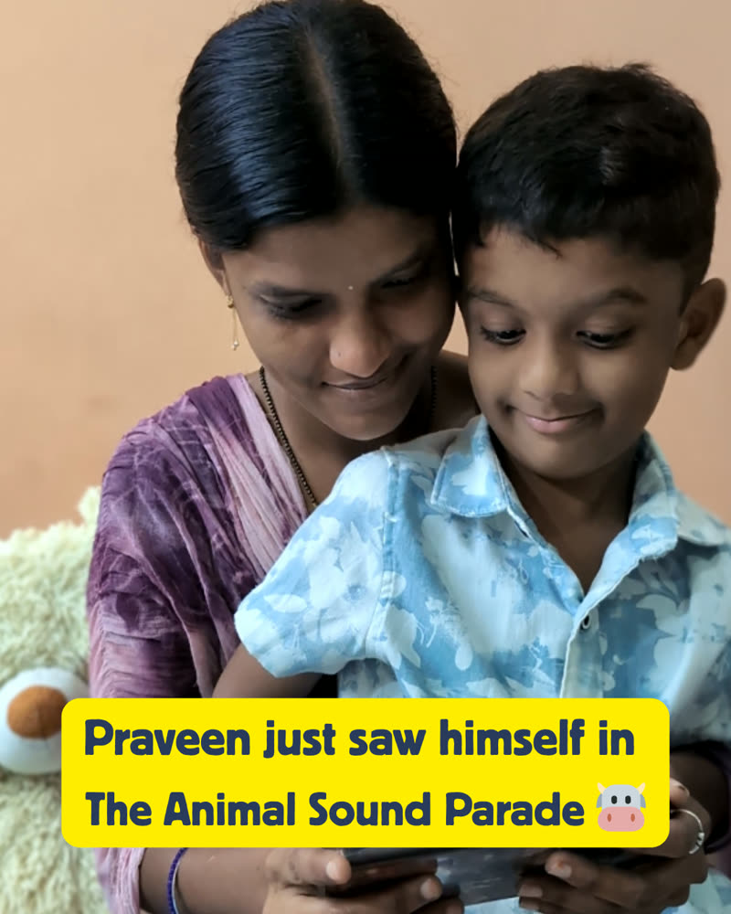 Praveen smiling with his mother as he reads The Animal Sound Parade with himself as the hero